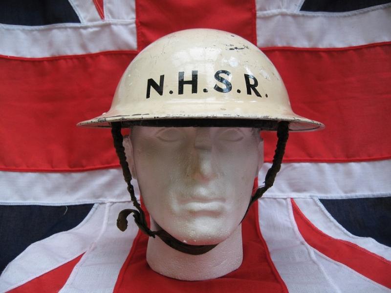 WWII Dated Brodie Helmet painted white with the N.H.S.R. to the front and revers