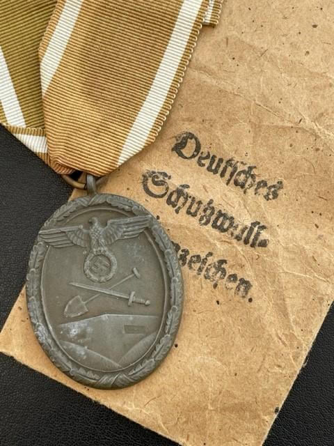 WWII GERMAN WEST WALL MEDAL WITH PAPER ISSUE PACKET.