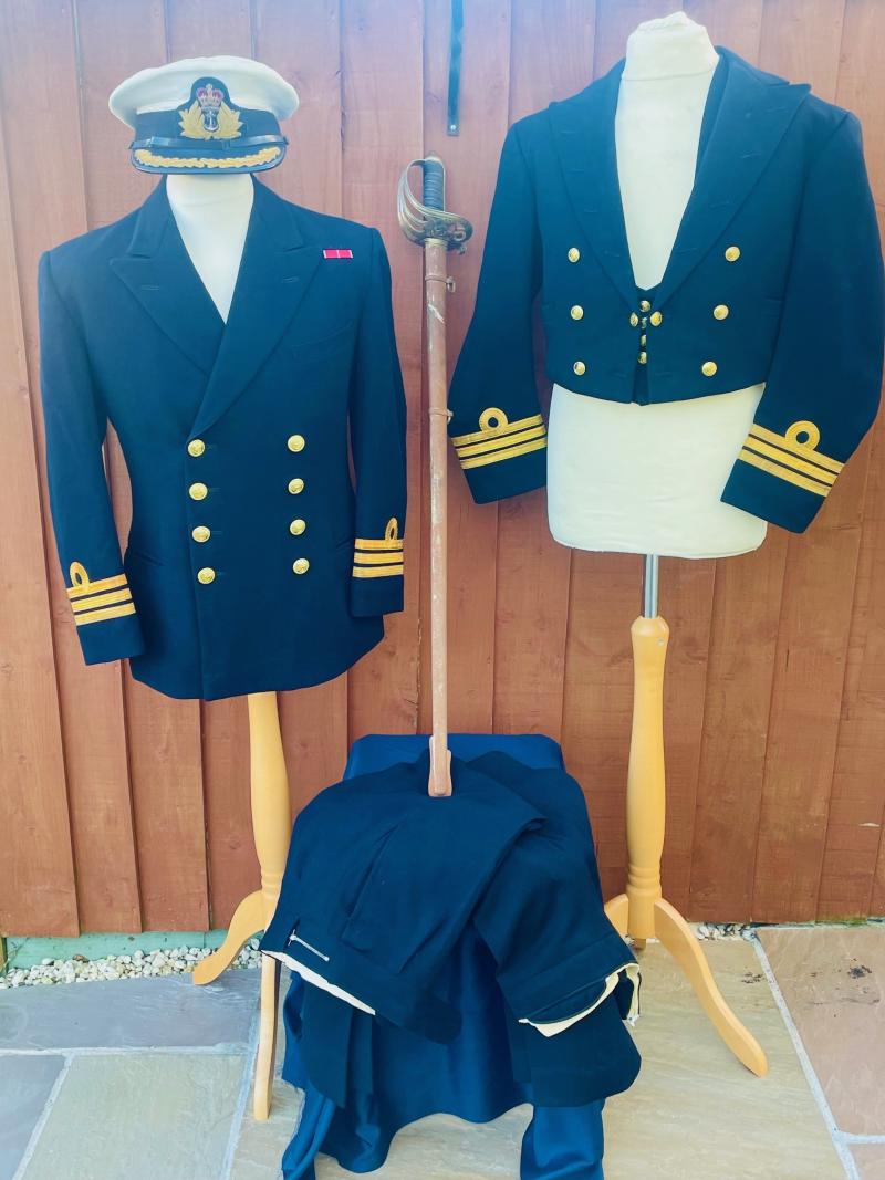 ORIGINAL NAMED ROYAL NAVY COMMANDERS DOUBLE SET OF UNIFORMS WITH OFFICERS SWORD.